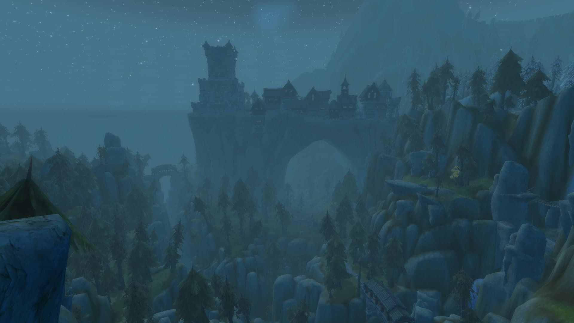 A distant view of Pale Reach across a misty valley filled with pine trees and waterfalls